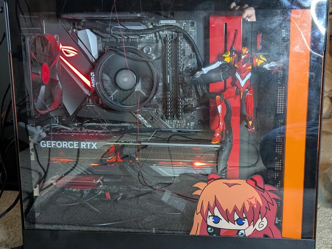 Desktop case with Asuka sticker and Unit 02 model kit posed inside it