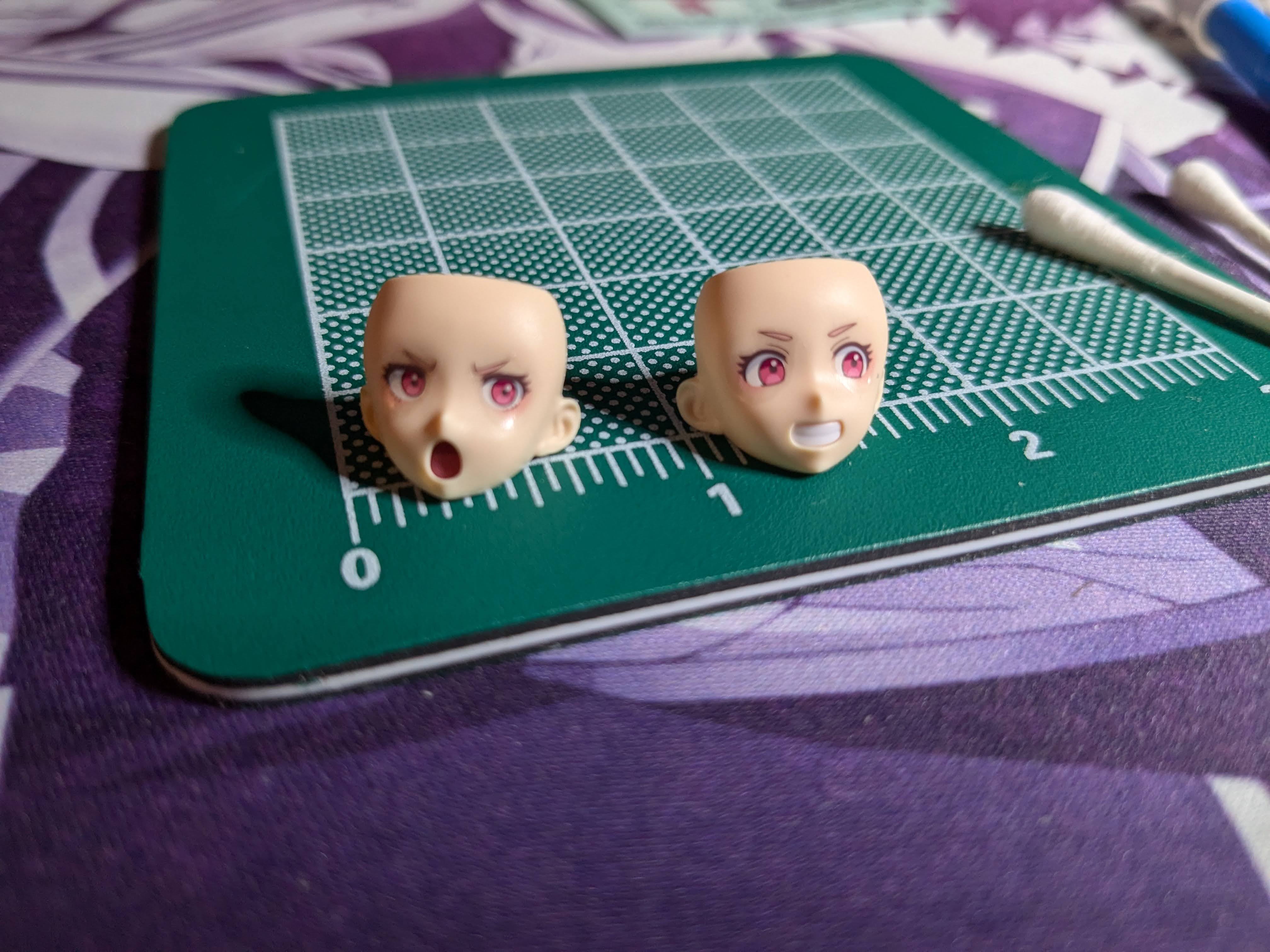 Two Chuchu faces with waterslide decal eyes applied